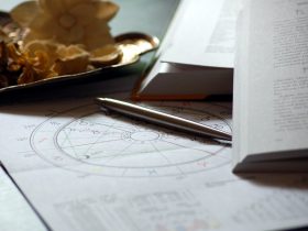 astrologický rádix na papieri, pero a otvorená kniha