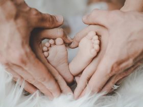 person holding baby s feet