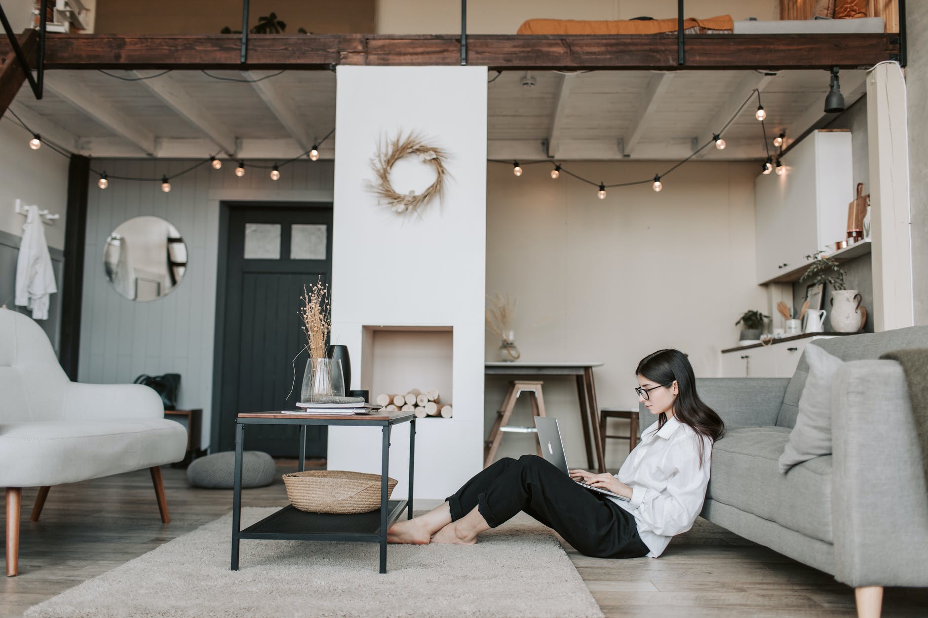 woman sitting on the floor using a laptop